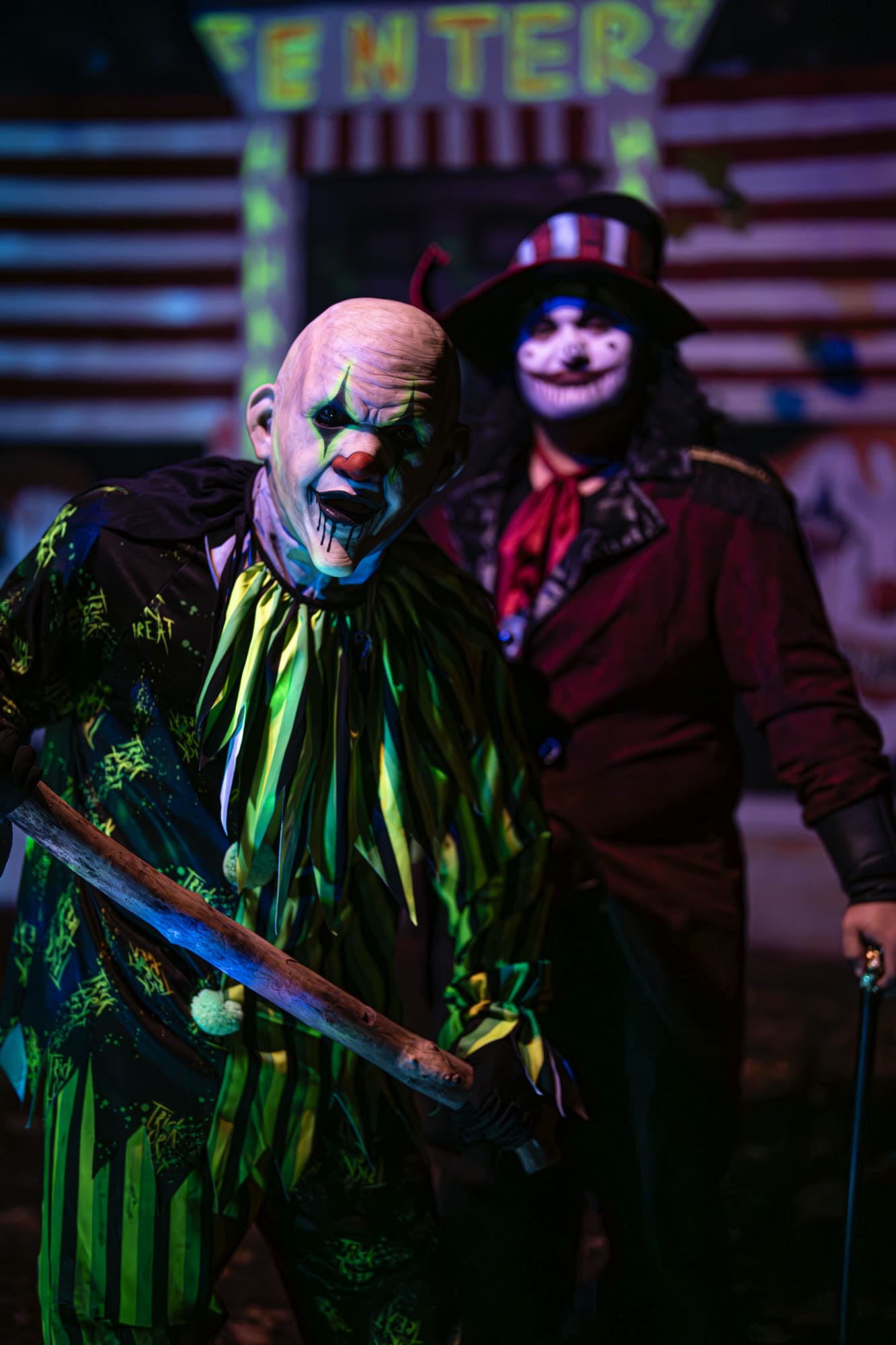 Two costumed characters, one in a striped top hat