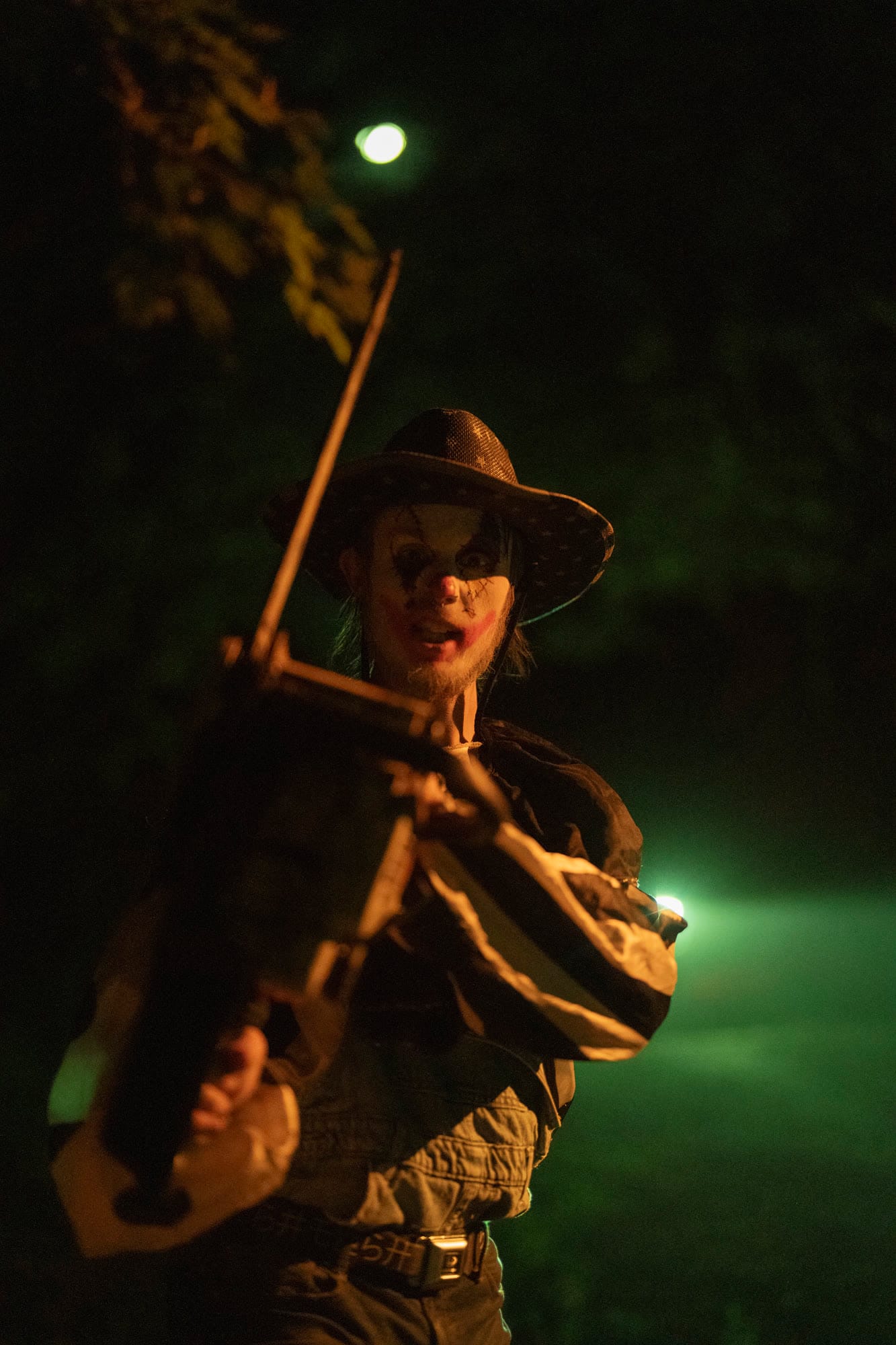 A scarecrow-like character holding a fiddle