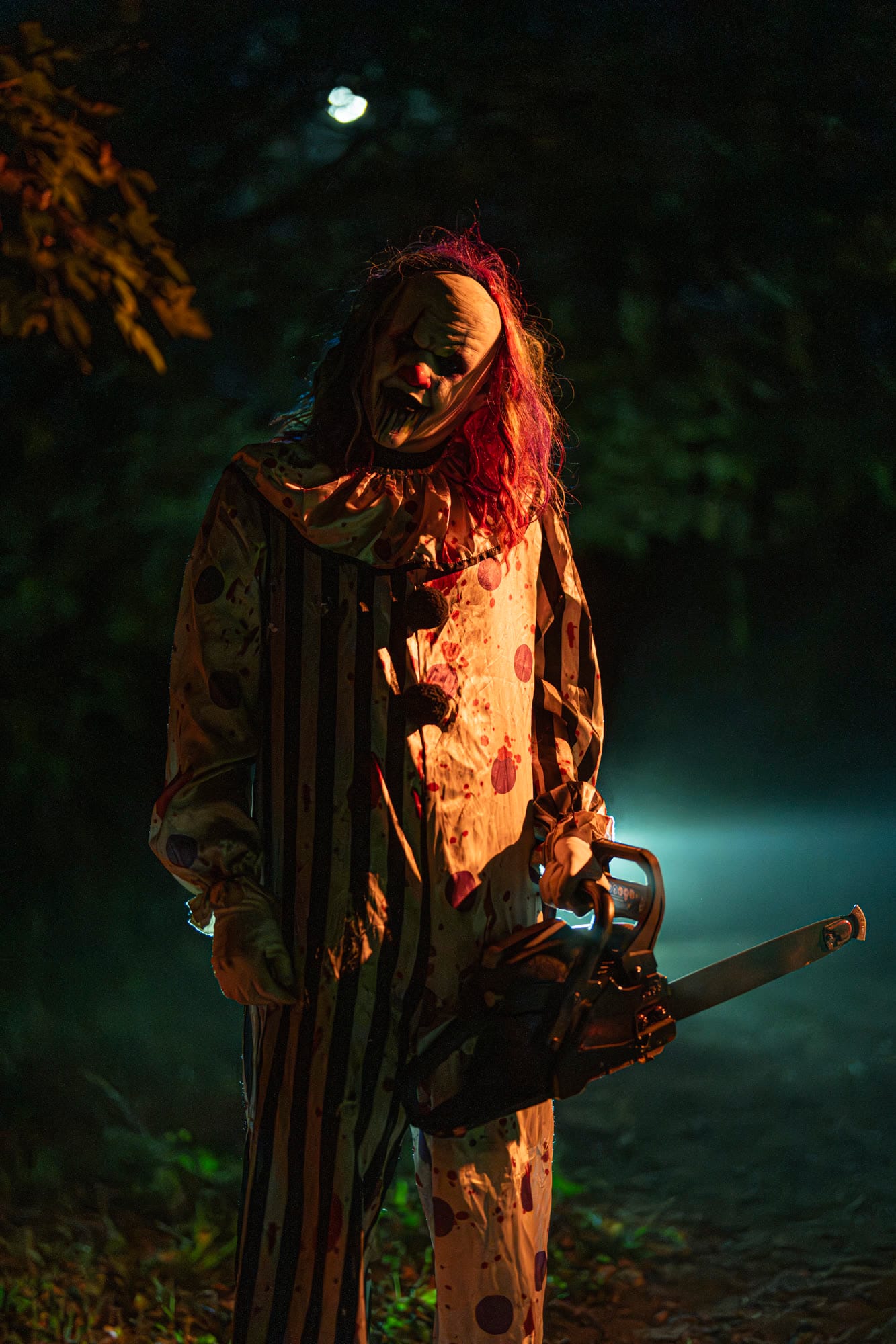 A costumed character holding a chainsaw
