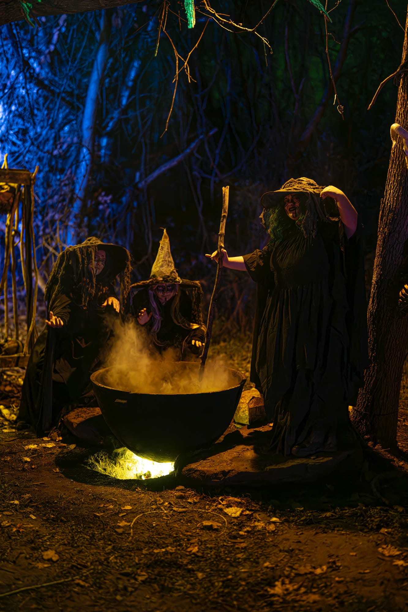 Three witches gathered around a cauldron