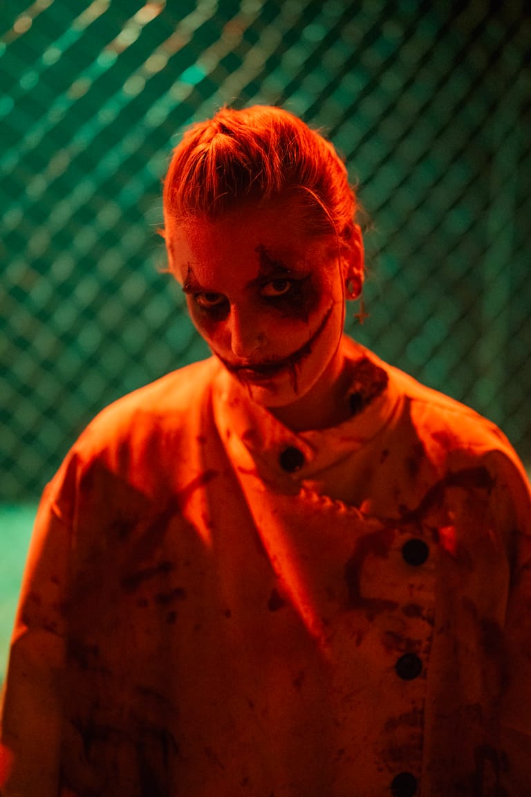 Costumed characters of VerHulst Haunted Hayride in the dark, lit by work lights